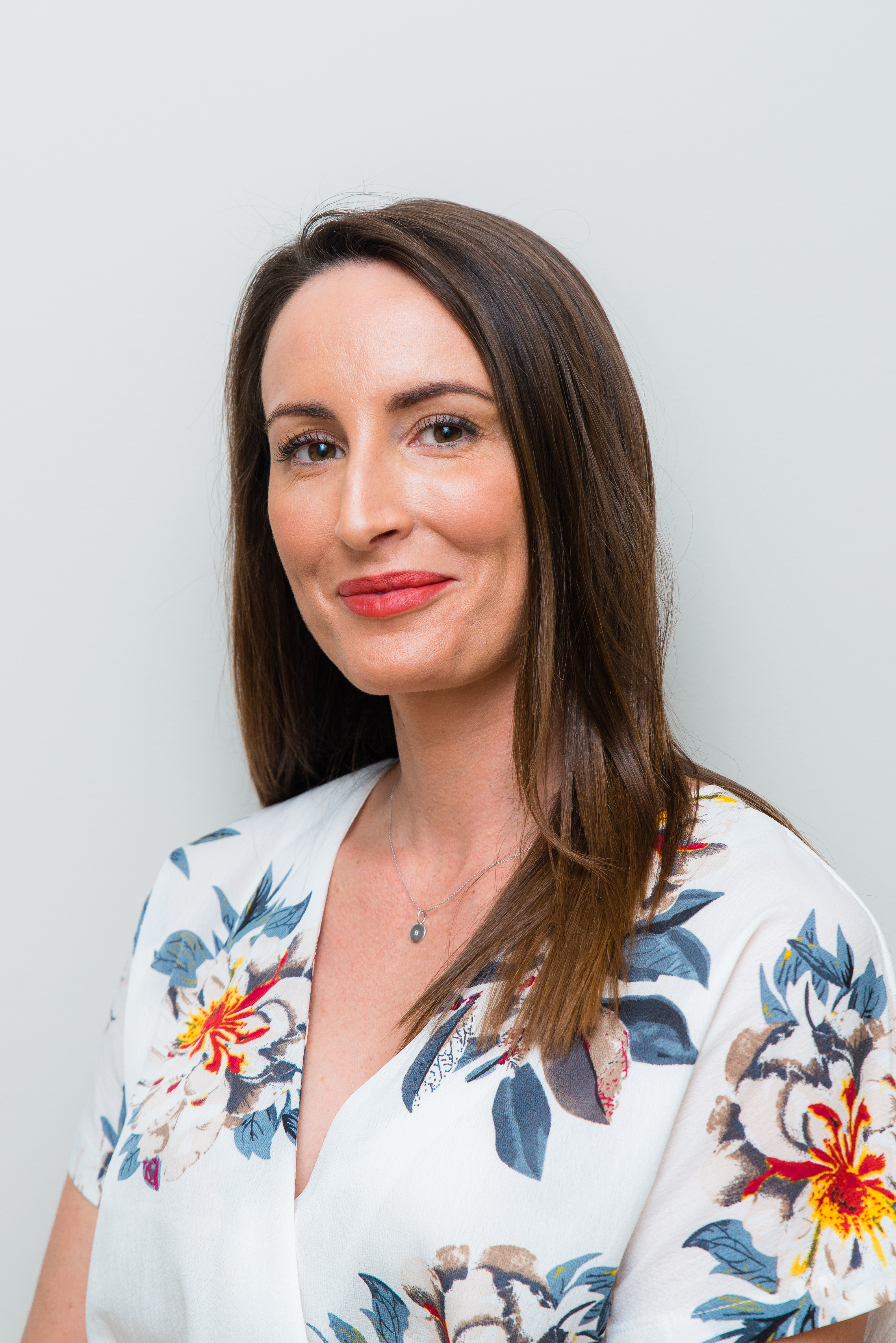 Studio headshot of a person in a professional setting